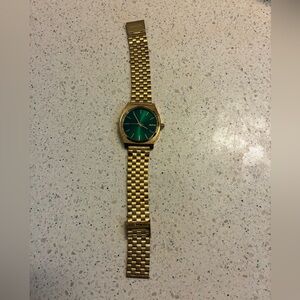 Gently Used Nixon Gold Watch with Green Dial.